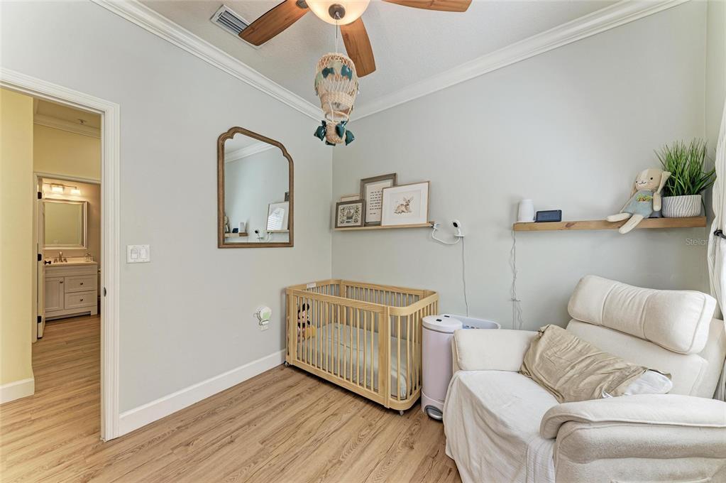8015 Limestone Lane, Unit 15101 Sarasota, FL 34233 - Photo 23 of 46 a living room with furniture and a wooden floor
