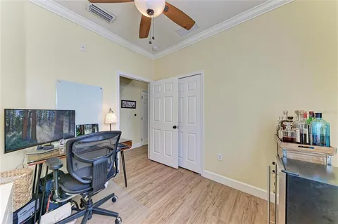 a view of a workspace with furniture and wooden floor