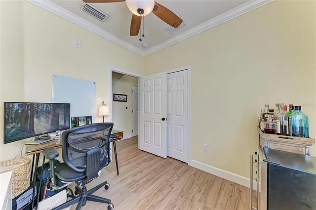 a view of a workspace with furniture and wooden floor