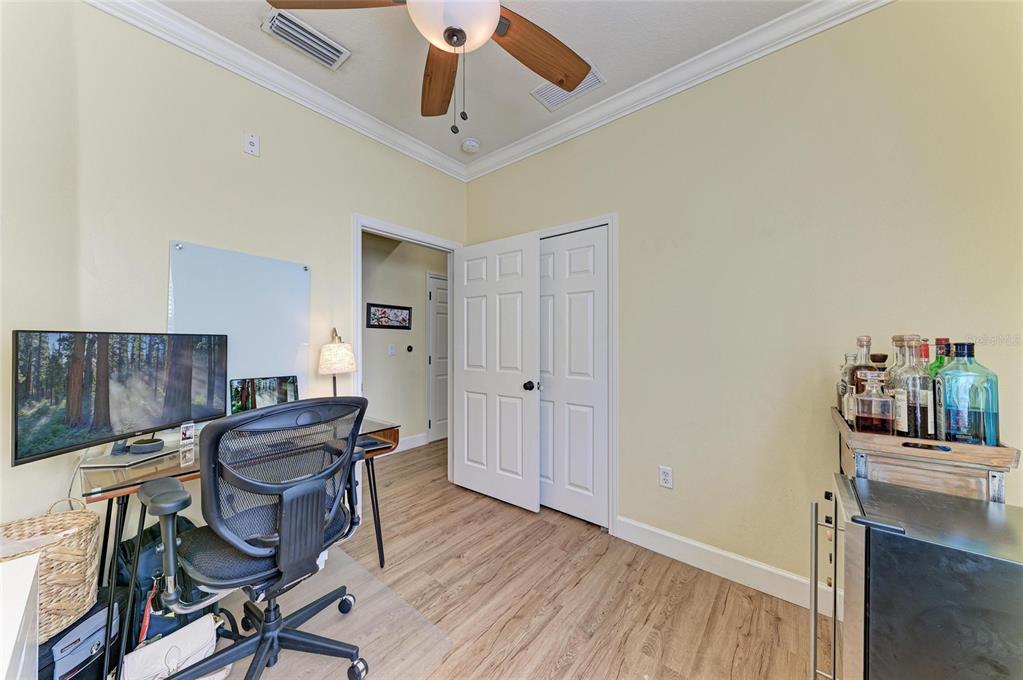 8015 Limestone Lane, Unit 15101 Sarasota, FL 34233 - Photo 26 of 46 a view of a workspace with furniture and wooden floor
