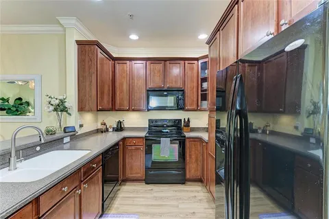 a kitchen with a sink stove and refrigerator