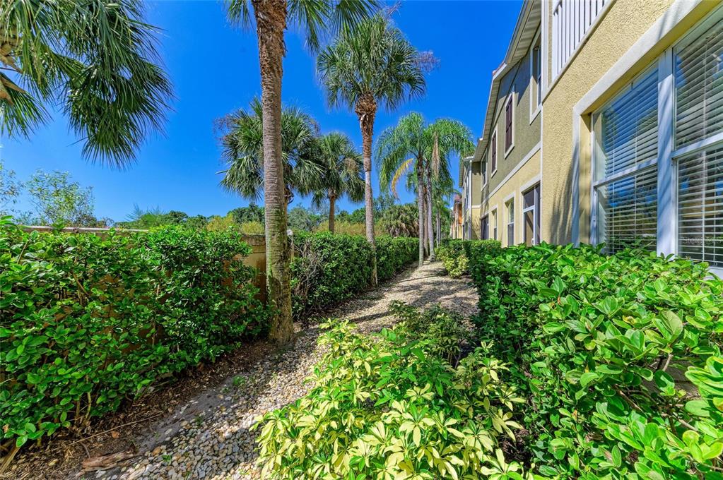8015 Limestone Lane, Unit 15101 Sarasota, FL 34233 - Photo 32 of 46 a view of a garden with a building