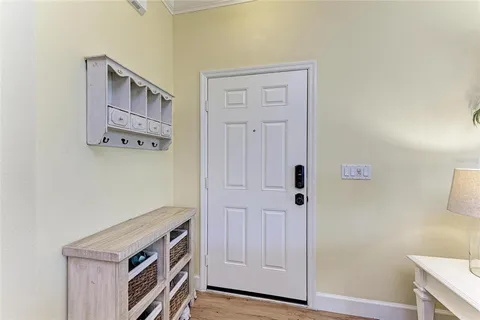 a view of an entryway with cabinets
