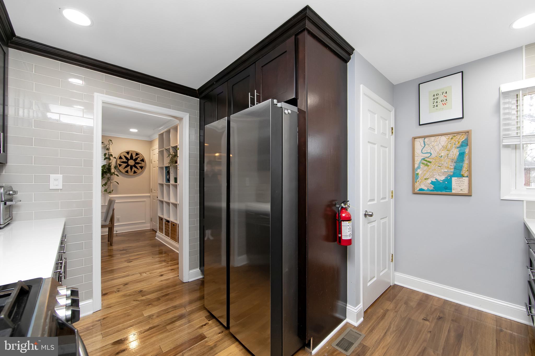 22 West 6th Avenue Runnemede, NJ 08078 - Photo 24 of 33 a view of a hallway with wooden floor and a living room