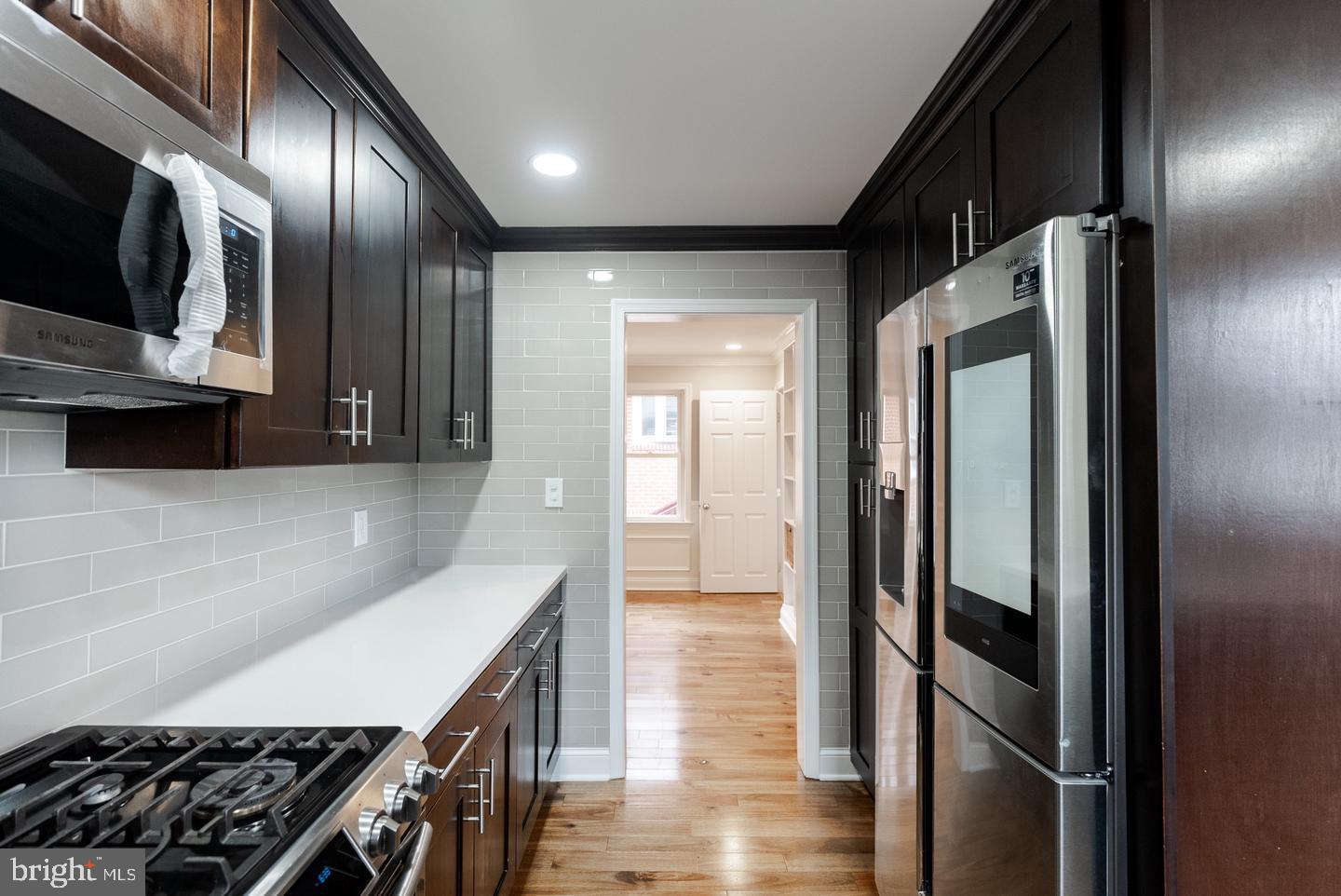 22 West 6th Avenue Runnemede, NJ 08078 - Photo 25 of 33 a kitchen with stainless steel appliances granite countertop a refrigerator and a stove top oven
