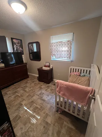 a living room with furniture and a mirror