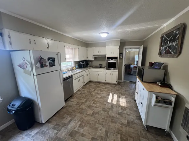 a kitchen with refrigerator and cabinets