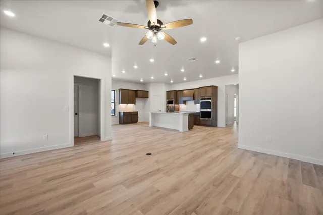 a view of kitchen and refrigerator