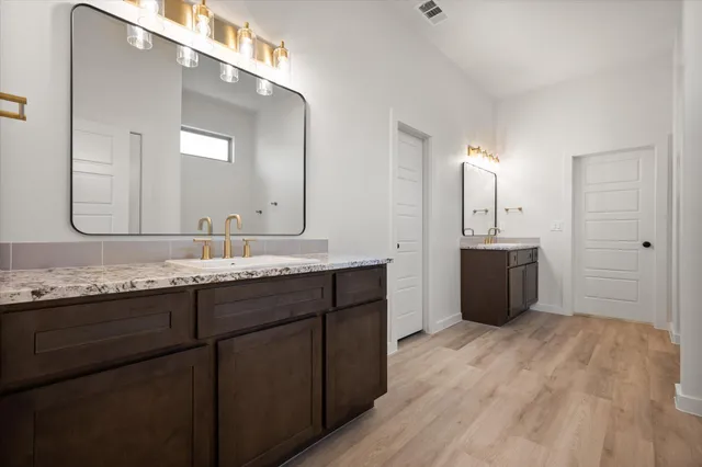 a bathroom with a double vanity sink mirror and