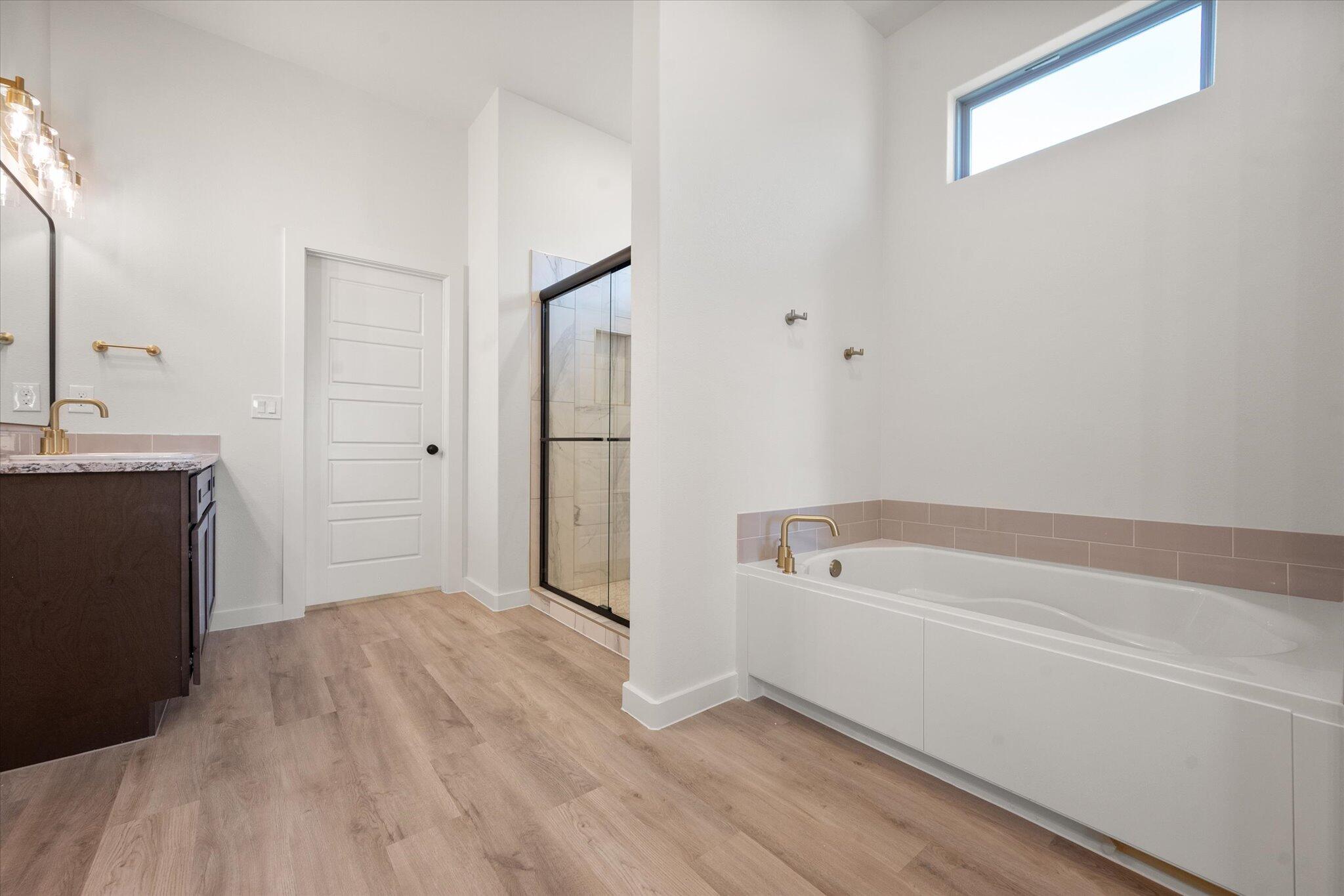 7010 16th Street Lubbock, TX 79416 - Photo 17 of 28 a bathroom with a tub shower and sink