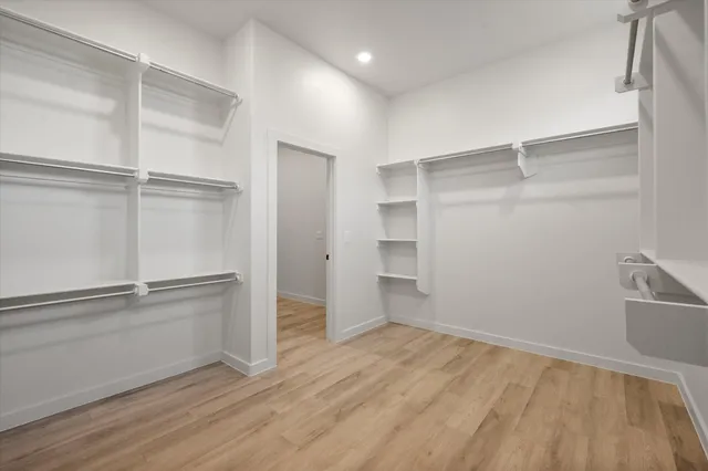 a view of an empty walk in closet with empty racks