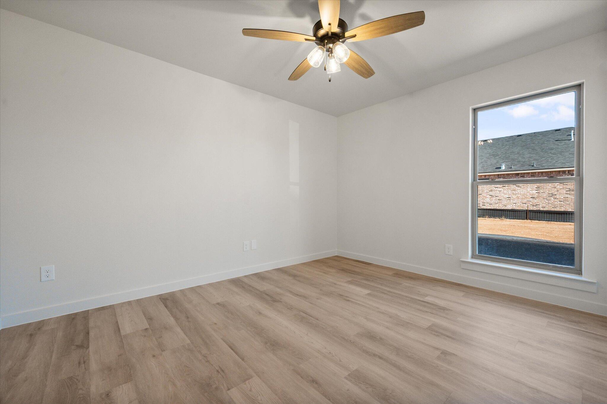 7010 16th Street Lubbock, TX 79416 - Photo 24 of 28 an empty room with a window and a fan