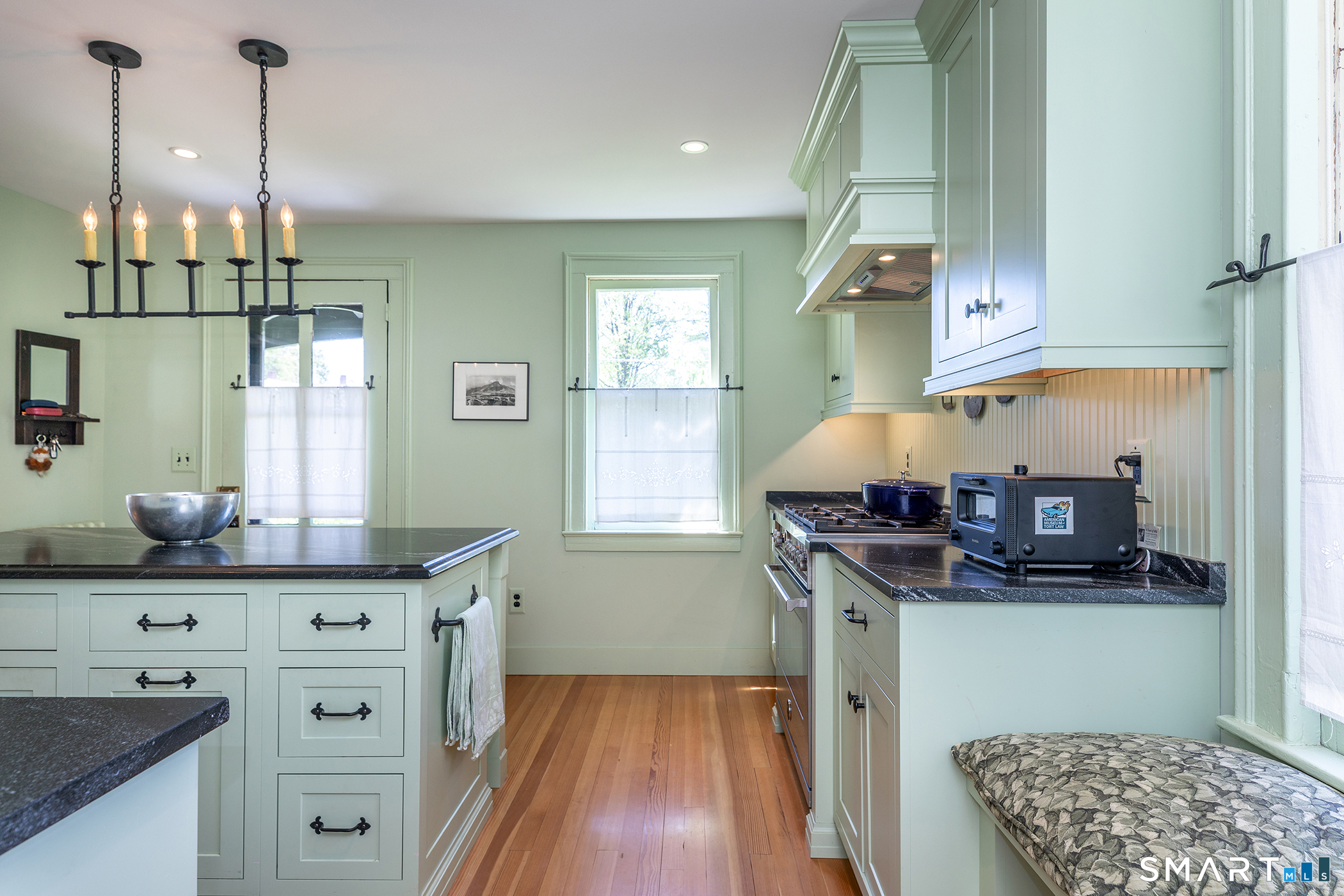 35 Maple Avenue Norfolk, CT 06058 - Photo 15 of 40 a kitchen with stainless steel appliances granite countertop a sink and a wooden floor