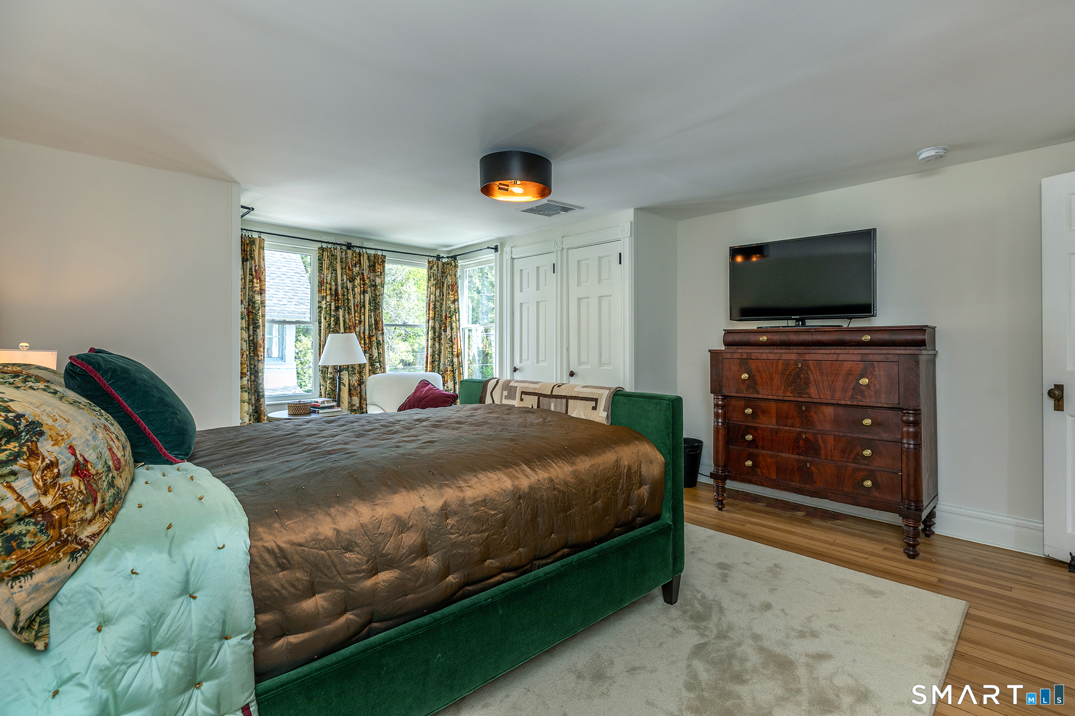 35 Maple Avenue Norfolk, CT 06058 - Photo 24 of 40 a bedroom with a bed and a television in it