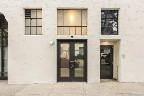 a living room with furniture and a dining table