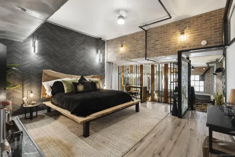 a bedroom with a bed a window and a walk in closet