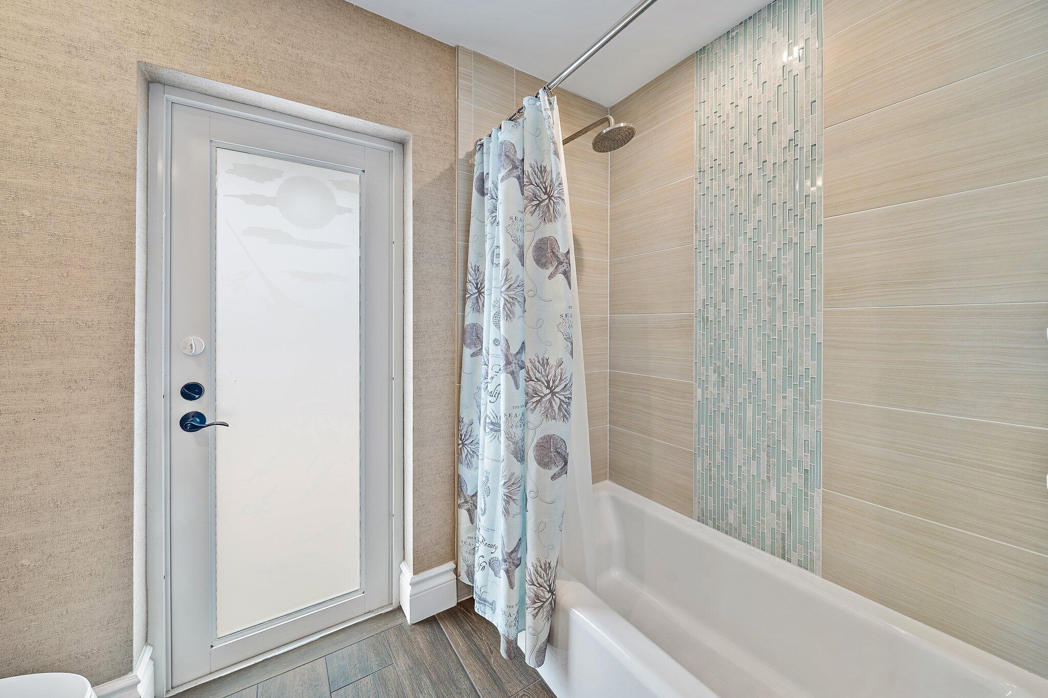 98 Golfview Drive Tequesta, FL 33469 - Photo 21 of 34 a bathroom with a shower and a tub