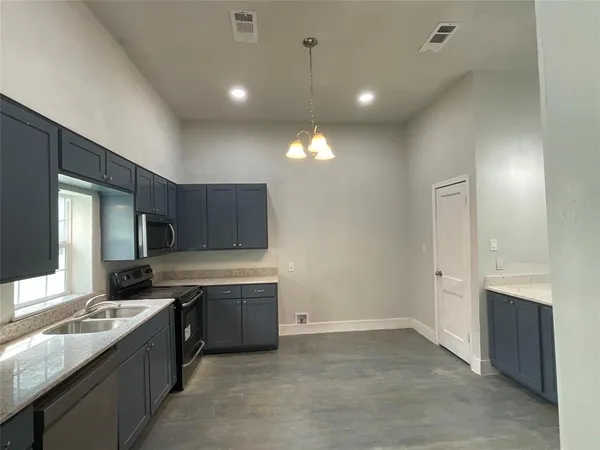 a kitchen with a sink stove and refrigerator