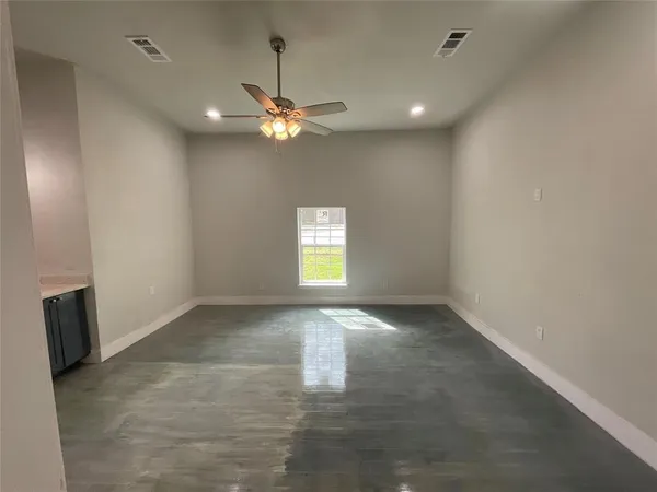 an empty room with a empty space and a window