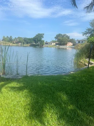 a view of a lake with houses in the back