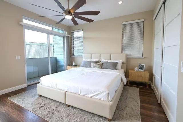 a bedroom with a large bed and a chandelier