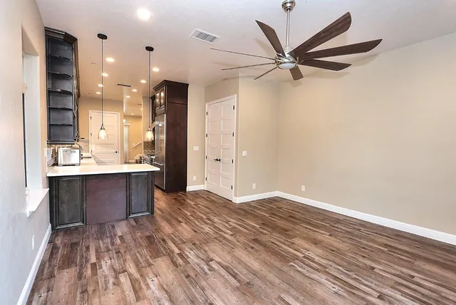 a kitchen with granite countertop a stove and cabinets