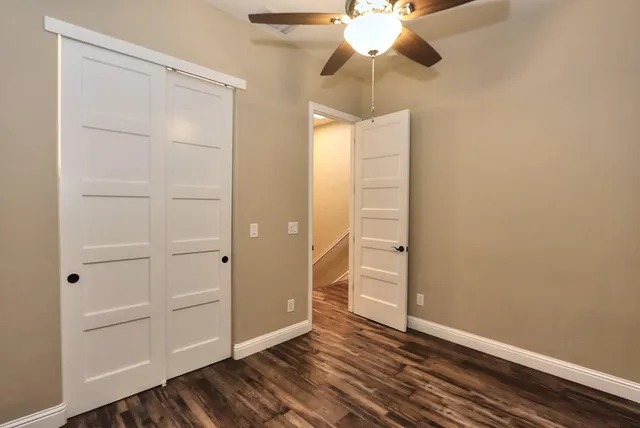a view of entryway and hall with wooden floor