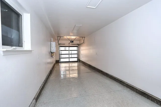 a view of a house with a patio and a yard