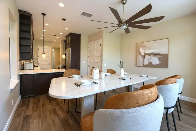 a dining room with furniture a window and a chandelier
