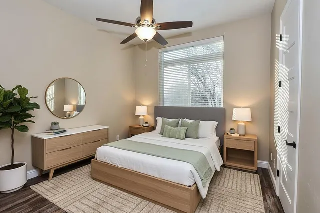 a bedroom with a large bed and a chandelier