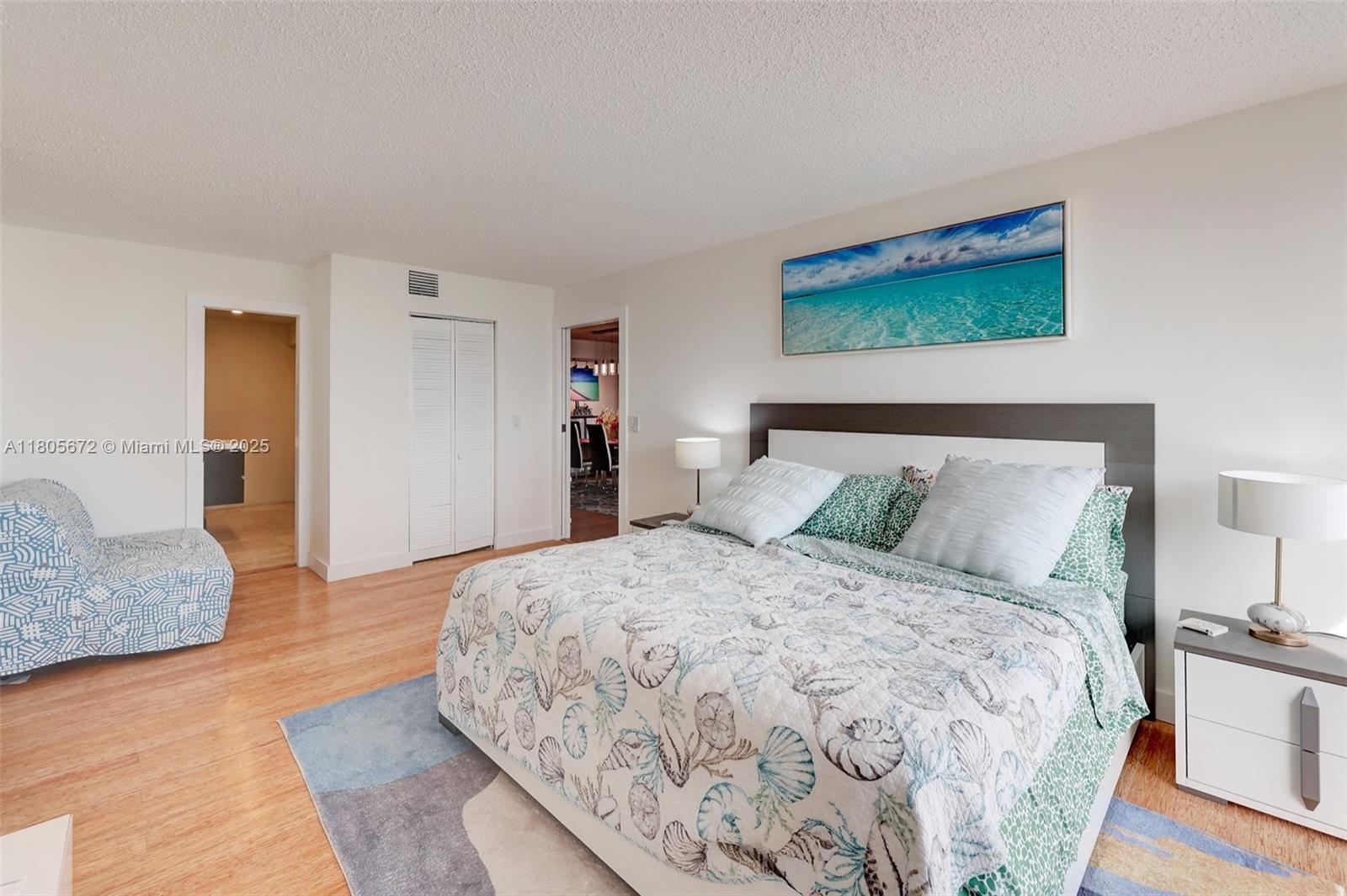 1500 South Ocean Drive, Unit 7J Hollywood, FL 33019 - Photo 26 of 54 a bedroom with a bed and wooden floor