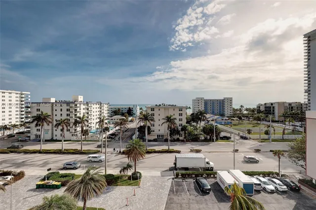 a living room with furniture and a book shelf