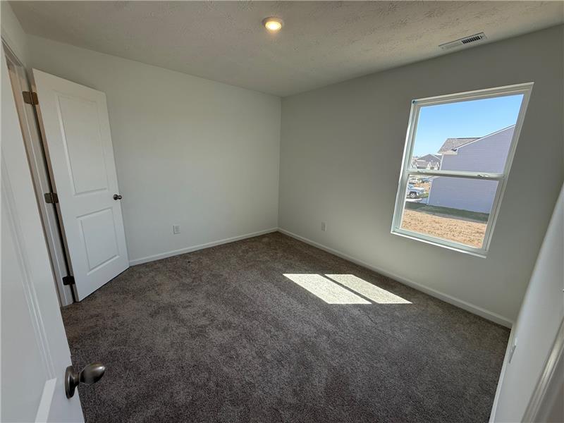 4005 Chakeres Avenue Springfield, OH 45505 - Photo 14 of 19 This spacious room offers comfort and ample natural light, perfect for restful living.