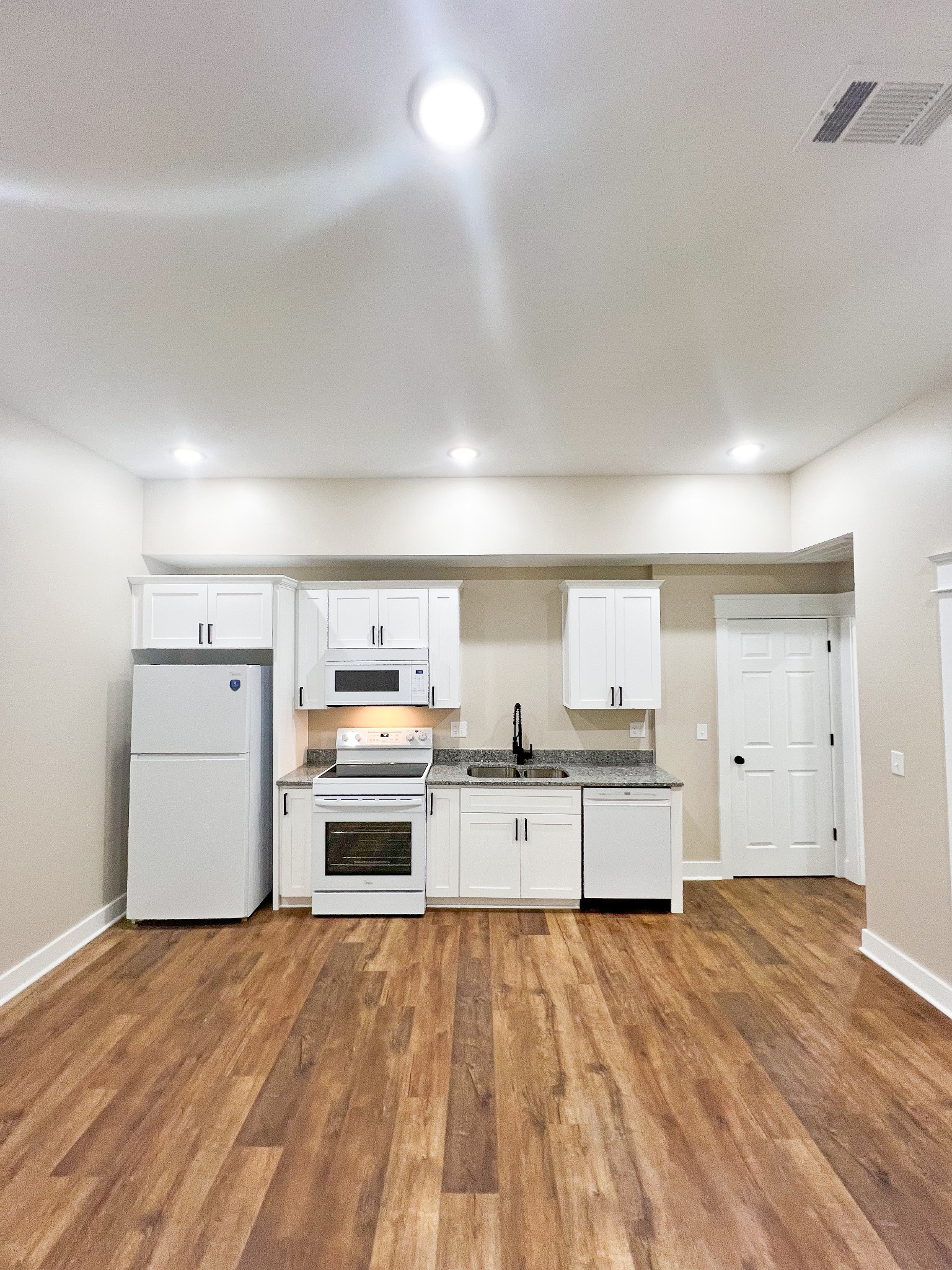 107 1st Avenue, Unit A Murfreesboro, TN 37130 - Photo 1 of 7 a kitchen with a stove top oven and refrigerator