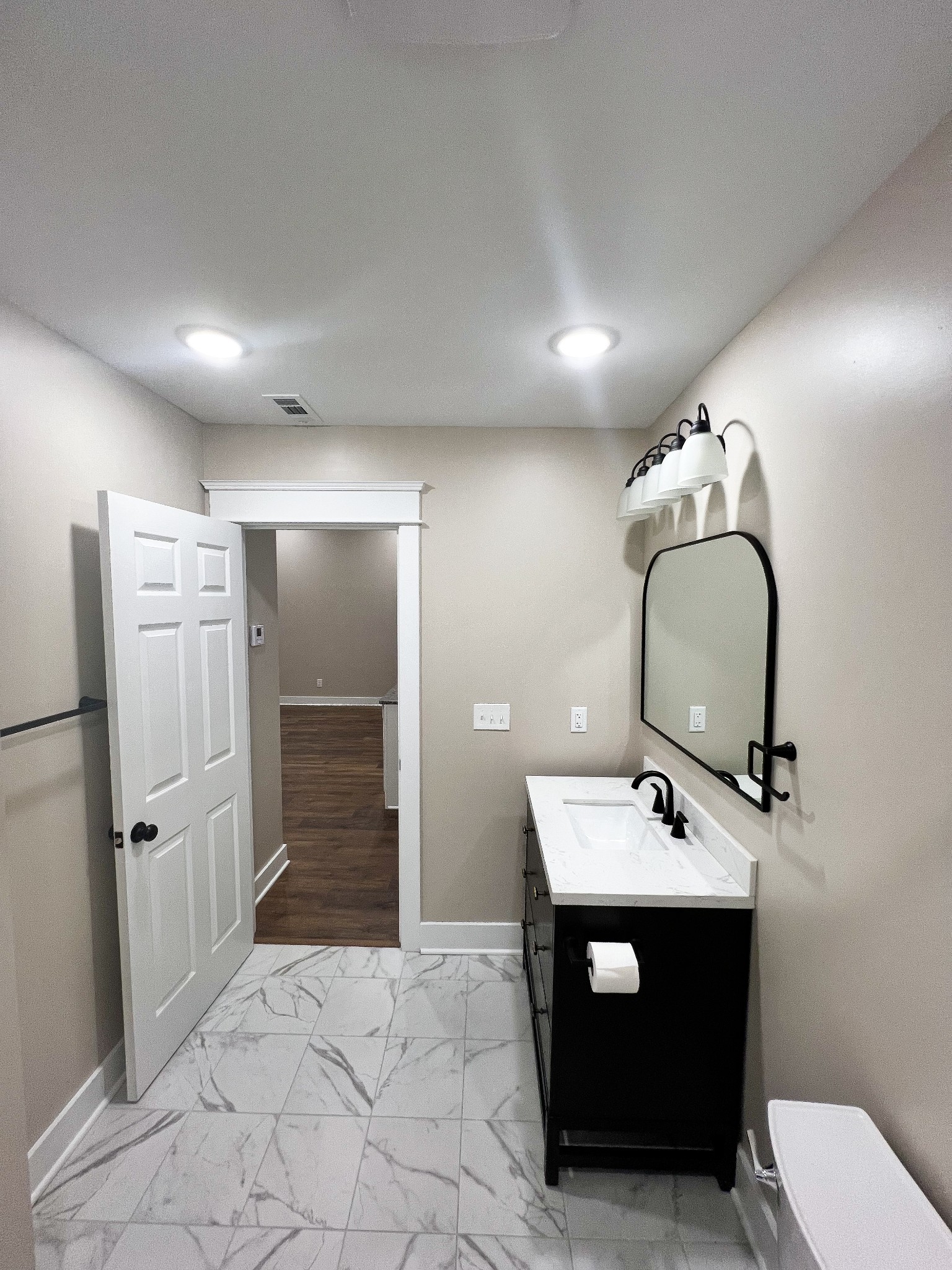 107 1st Avenue, Unit A Murfreesboro, TN 37130 - Photo 5 of 7 a bathroom with a sink mirror and toilet