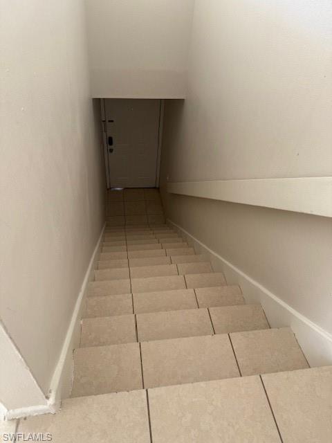 153 Santa Clara Drive, Unit 10 Naples, FL 34104 - Photo 32 of 33 an empty room with a bench