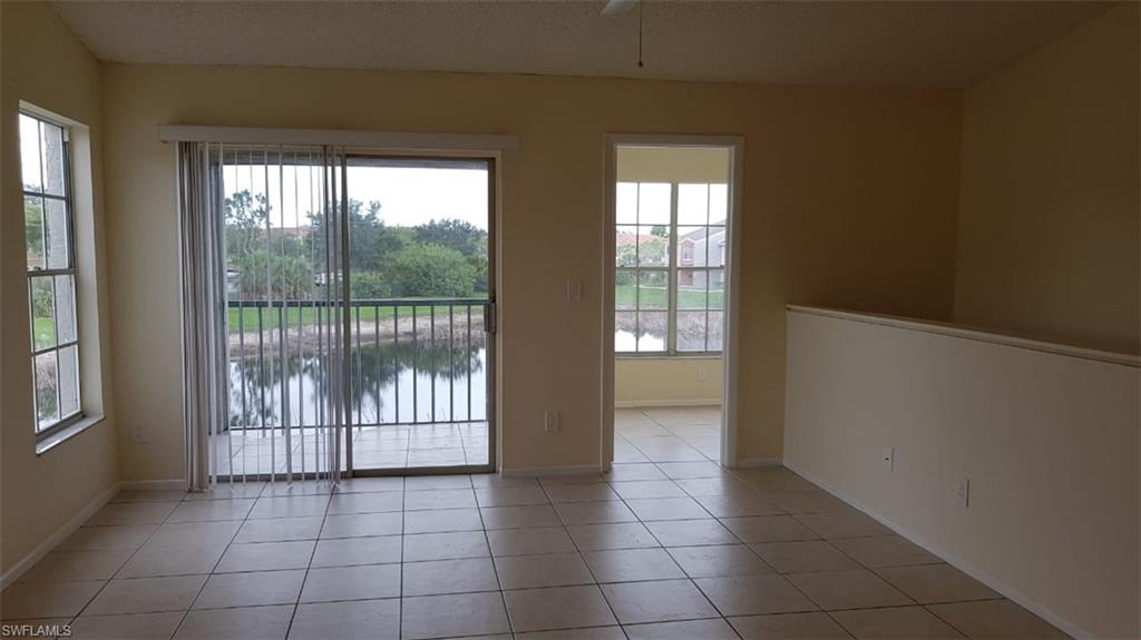 153 Santa Clara Drive, Unit 10 Naples, FL 34104 - Photo 4 of 33 en empty room with windows