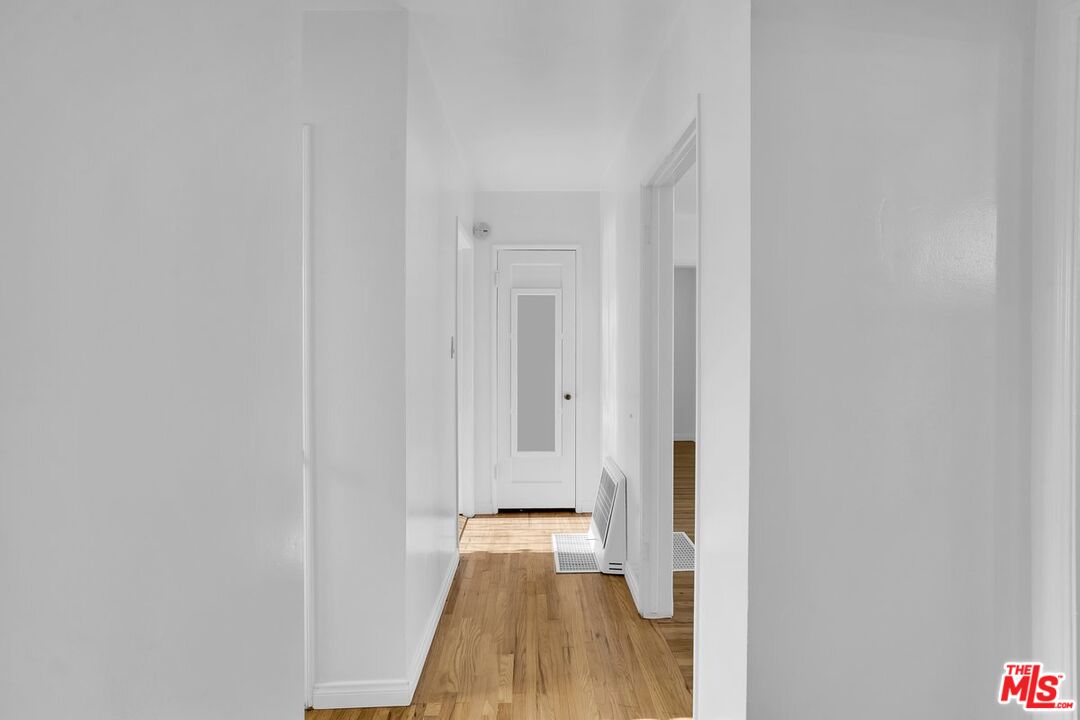 1316 South Castlegate Avenue Compton, CA 90221 - Photo 13 of 28 a view of a room with wooden floor and staircase