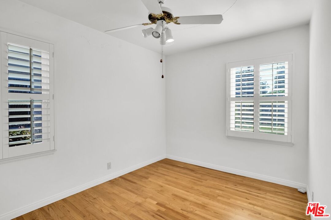 1316 South Castlegate Avenue Compton, CA 90221 - Photo 16 of 28 a view of an empty room with a window and wooden floor