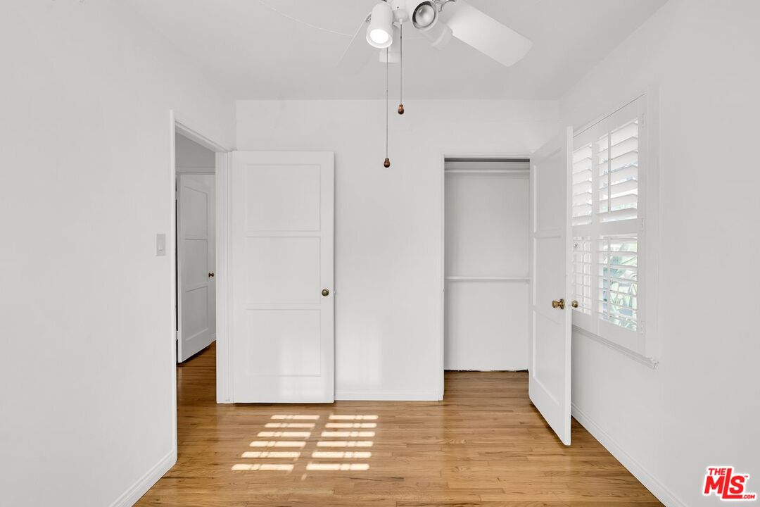 1316 South Castlegate Avenue Compton, CA 90221 - Photo 17 of 28 a view of an empty room with wooden floor and a window
