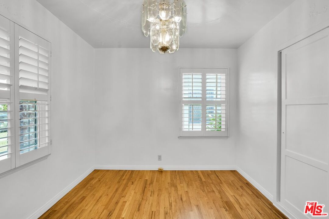 1316 South Castlegate Avenue Compton, CA 90221 - Photo 18 of 28 a view of empty room with wooden floor and fan