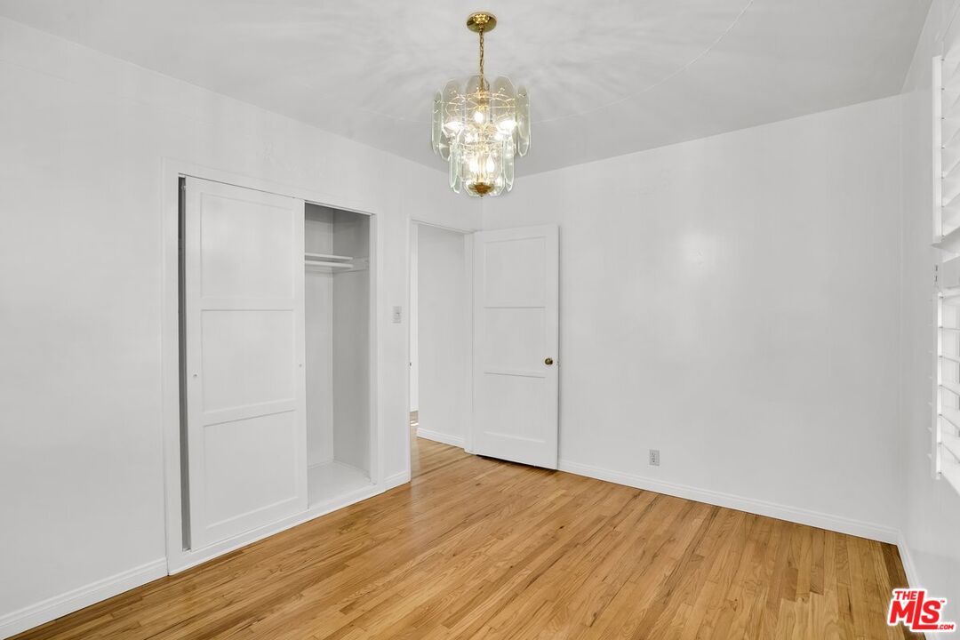 1316 South Castlegate Avenue Compton, CA 90221 - Photo 19 of 28 a view of an empty room with window and wooden floor