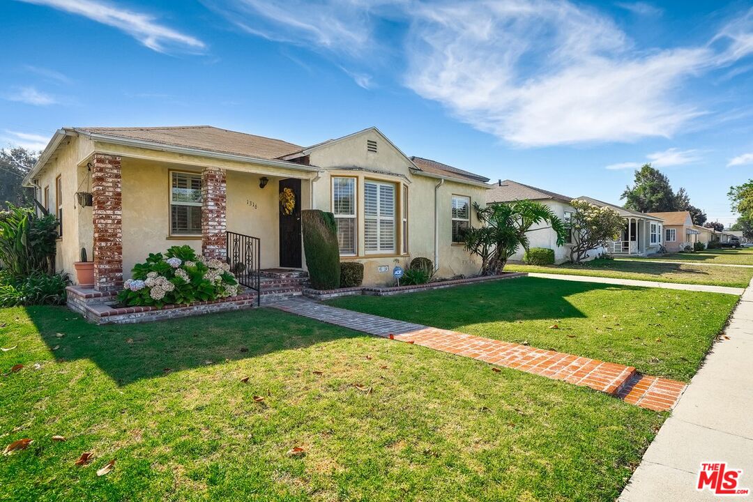 1316 South Castlegate Avenue Compton, CA 90221 - Photo 2 of 28 a front view of a house with a yard