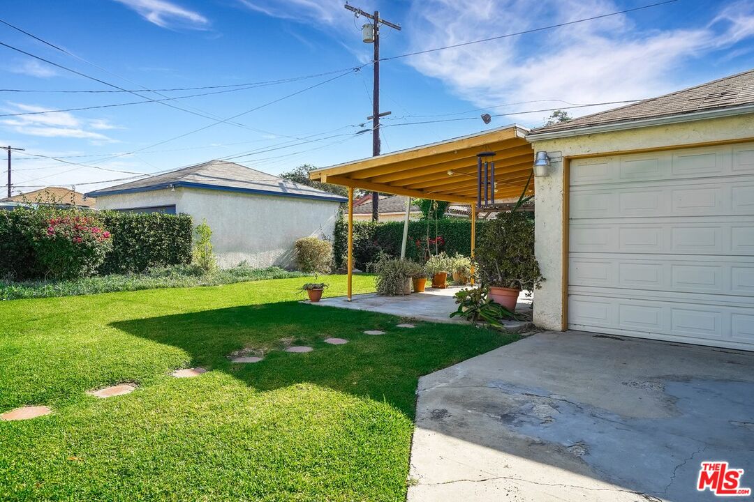 1316 South Castlegate Avenue Compton, CA 90221 - Photo 22 of 28 a view of a house with backyard porch and sitting area