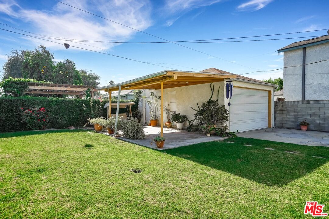 1316 South Castlegate Avenue Compton, CA 90221 - Photo 23 of 28 a view of a patio with a table and chairs under an umbrella