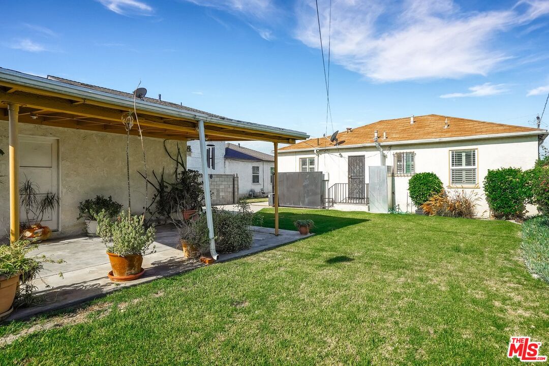1316 South Castlegate Avenue Compton, CA 90221 - Photo 24 of 28 a front view of a house with a yard