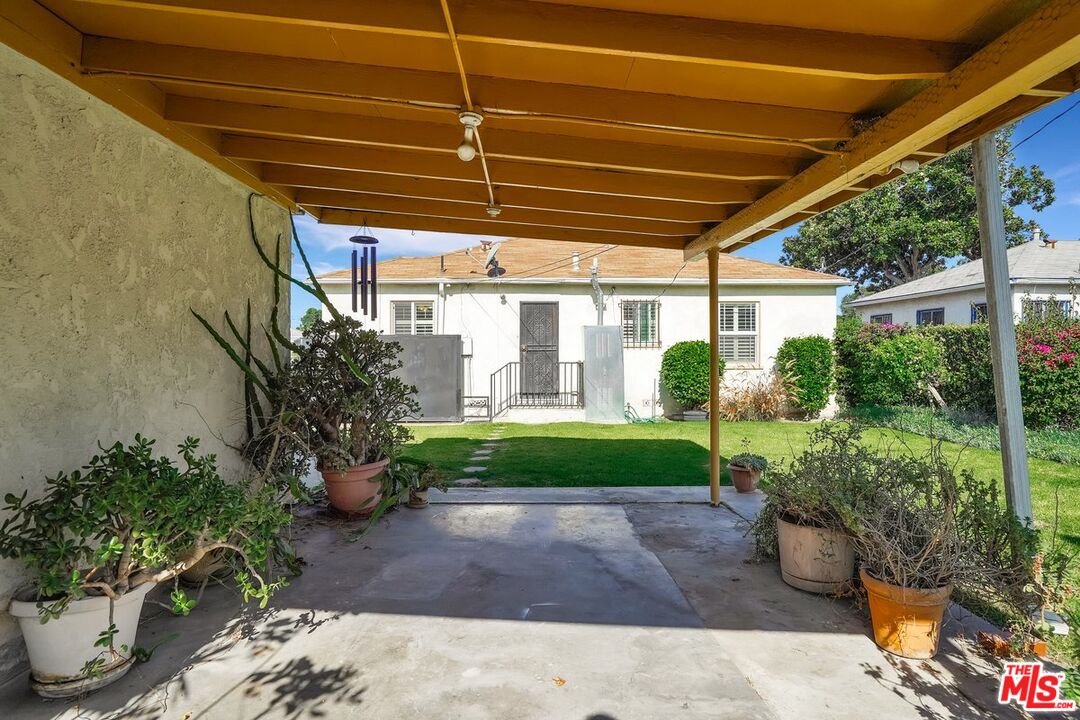 1316 South Castlegate Avenue Compton, CA 90221 - Photo 25 of 28 a front view of a house with garden