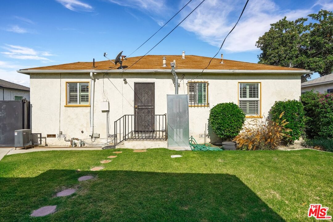 1316 South Castlegate Avenue Compton, CA 90221 - Photo 26 of 28 a front view of a house with a yard and garage
