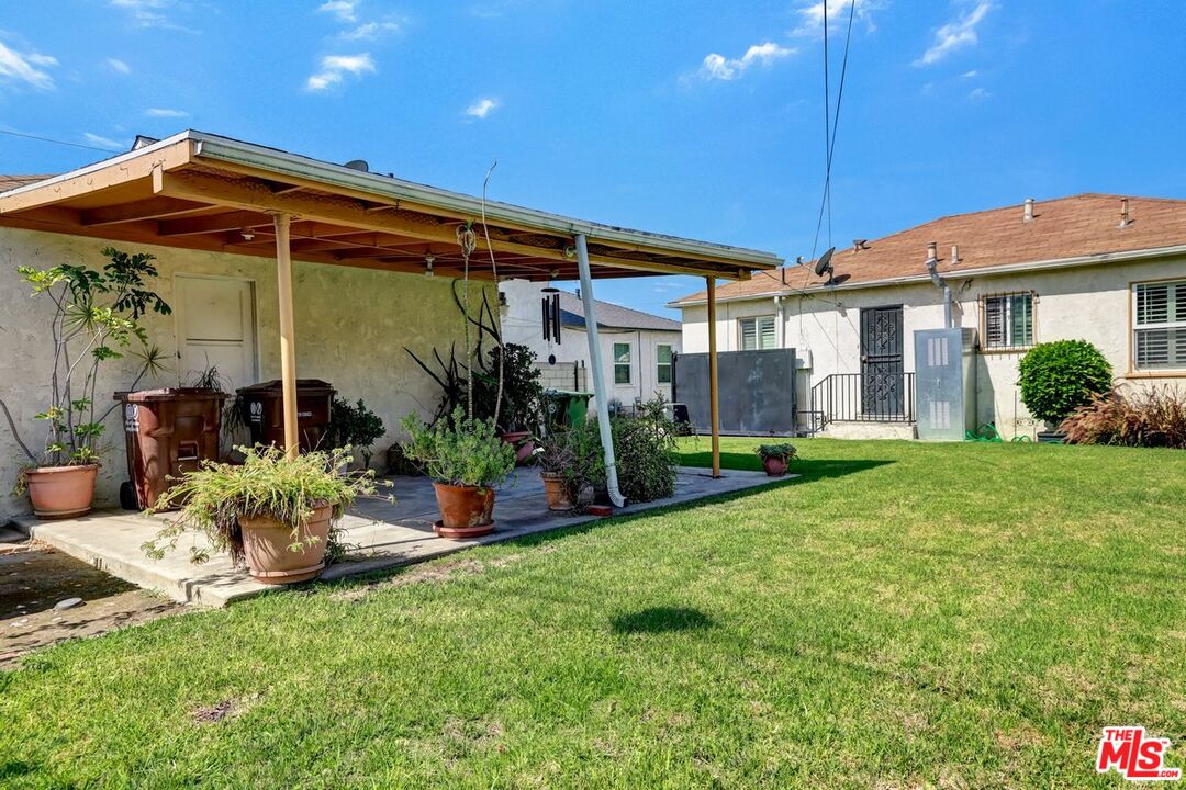 1316 South Castlegate Avenue Compton, CA 90221 - Photo 27 of 28 a view of a chair and table of the patio