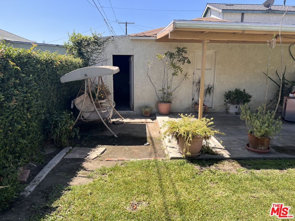 1316 South Castlegate Avenue Compton, CA 90221 - Photo 28 of 28 a roof deck with table and chairs potted plants